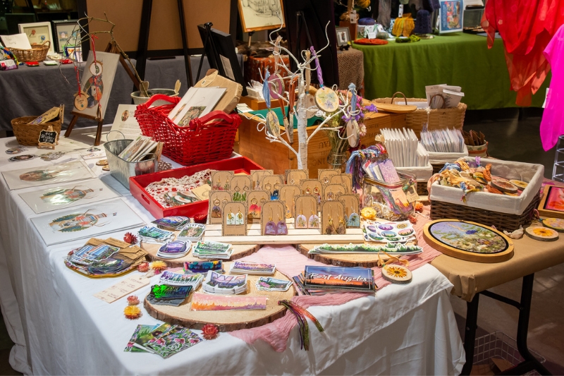 Table with earrings, stickers and ornaments displayed for 2021 Makers Market. Artist: Sarah Neco